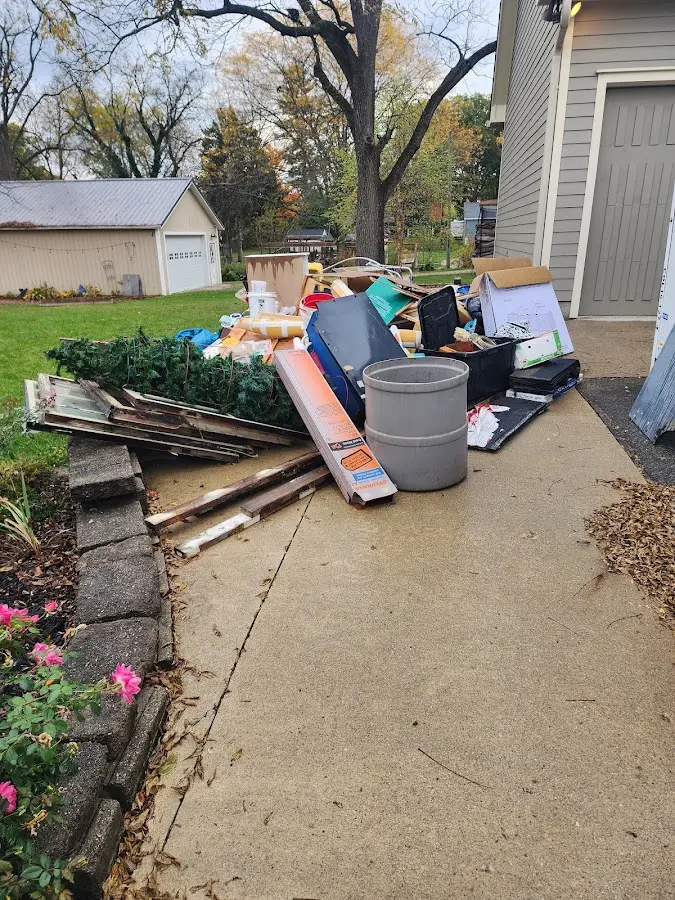 Dumpster being loaded with debris for 12 Yard Dumpster Rental in Lapeer